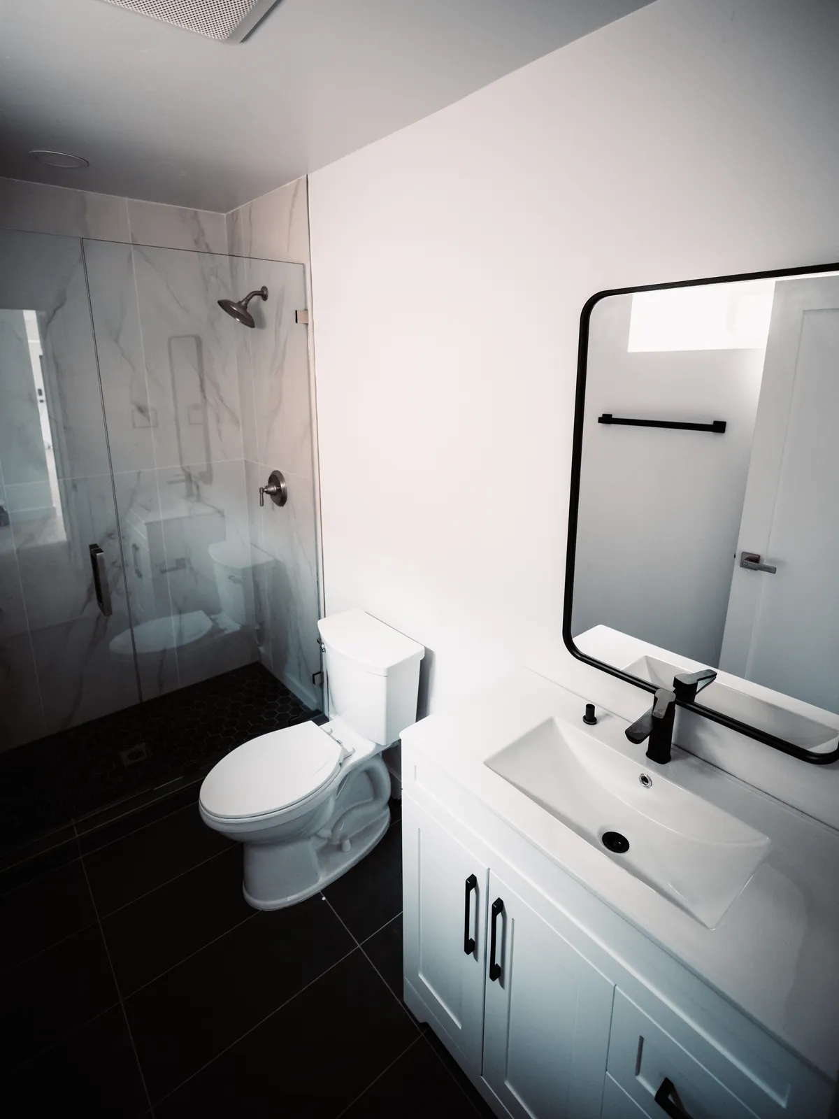 Bathroom with dark tile and matte black fixtures