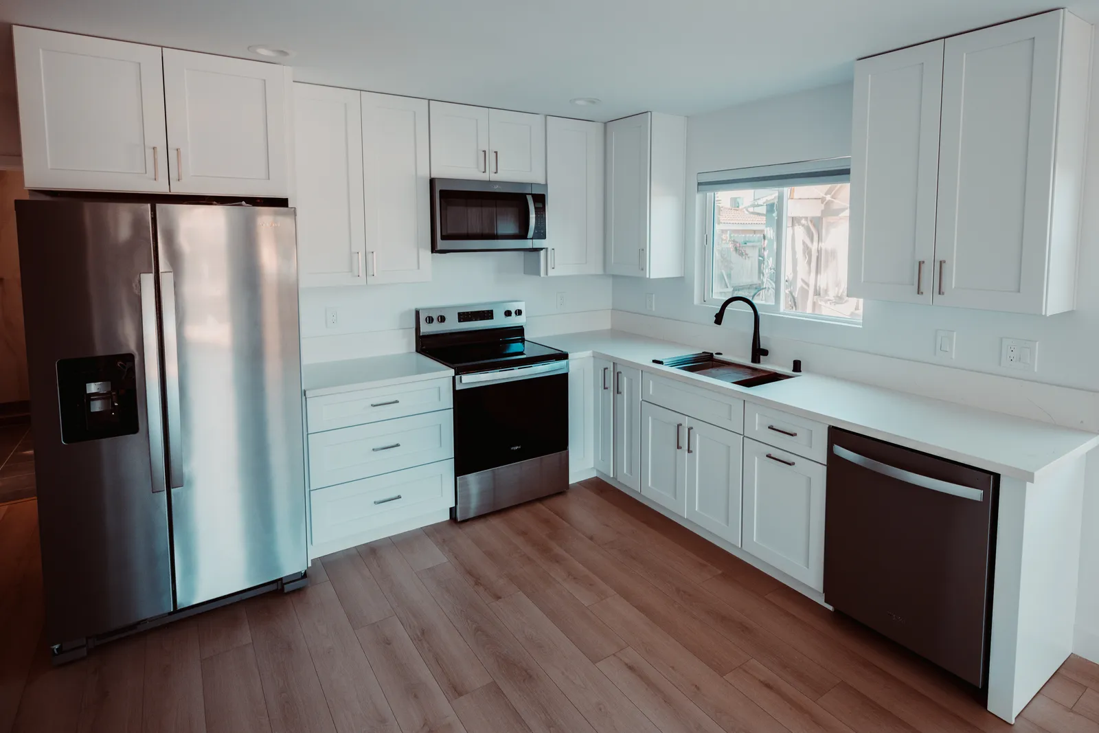 White kitchen with stainless appliances